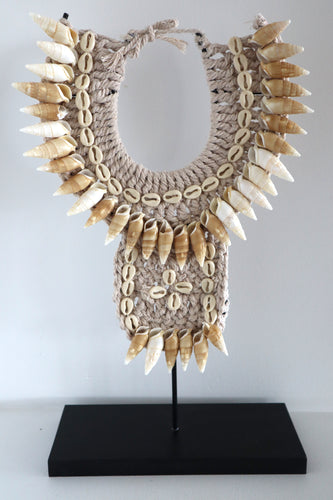 Tribal shell necklace on a stand