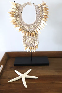 Tribal shell necklace on a stand